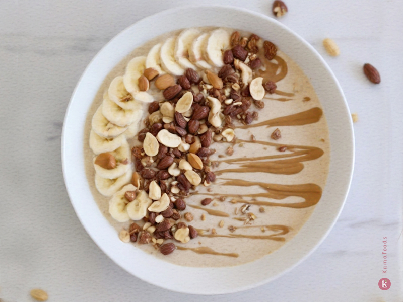 Peanut Butter Smoothie Bowl topped with banana slices and granola.