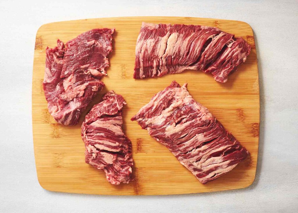 Alt Text: "Preparing skirt steak for authentic fajitas, showcasing traditional meat used in Tex-Mex cuisine."
